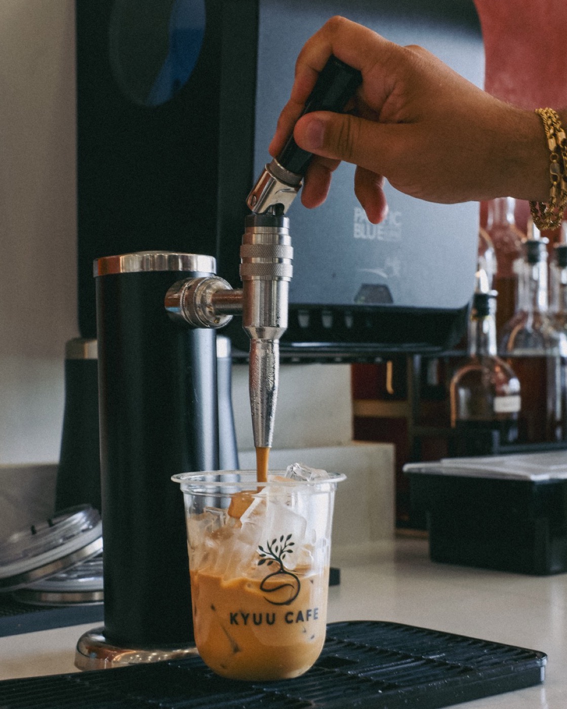 Nitro brown butter brown sugar latte pouring into a Kyuu Cafe cup