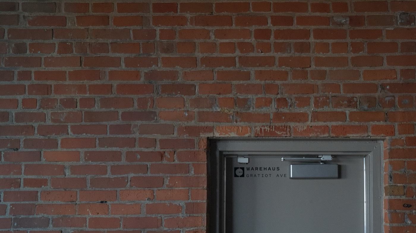 The Coffeehaus Warehaus on Gratiot Ave, brick facade with the Coffeehaus mark on the receiving door
