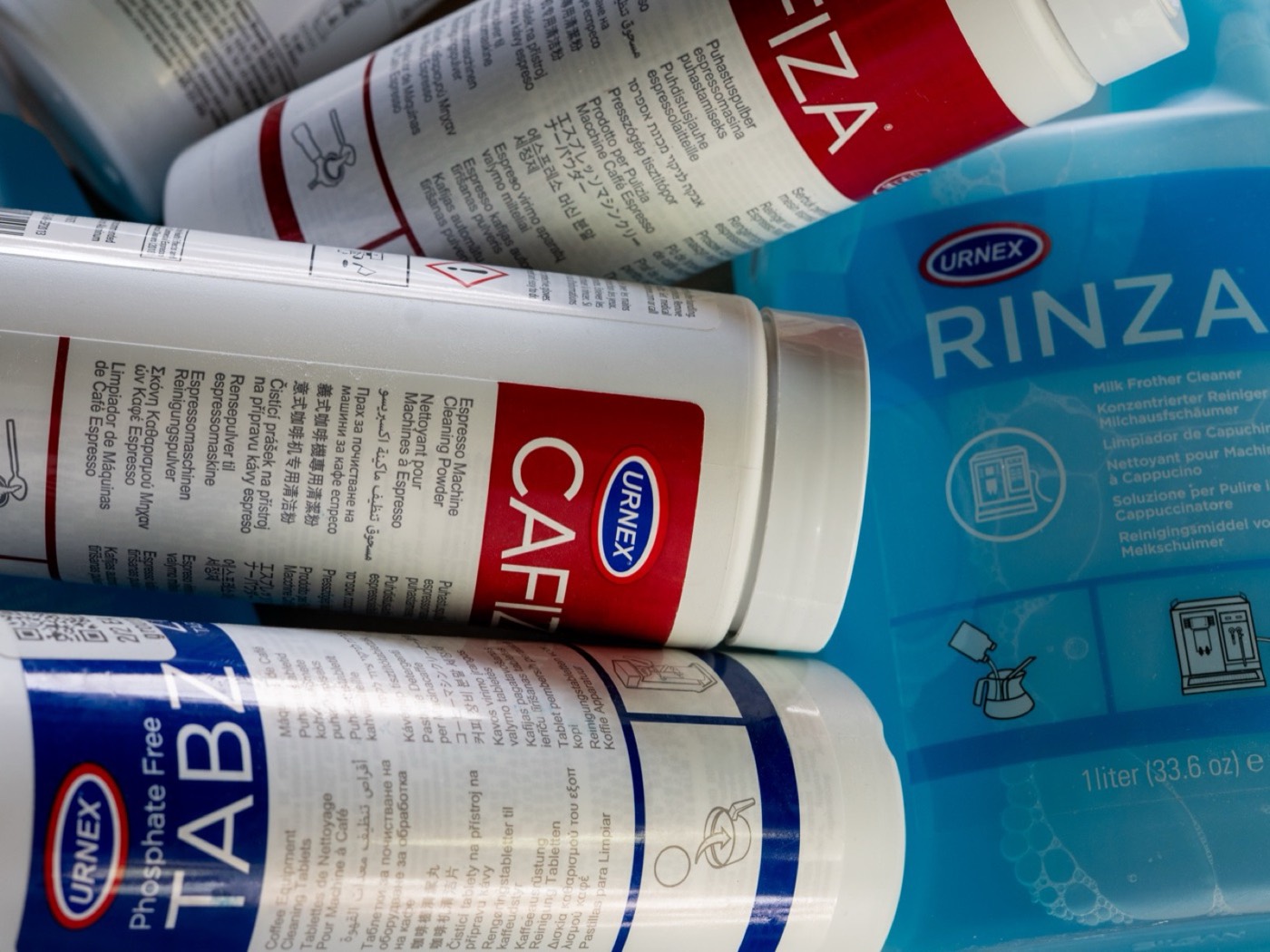 Urnex espresso cleaning supplies, Cafiza powder, Rinza milk frother cleaner, and Tabz cleaning tablets